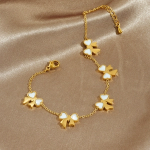 Gold plated stainless steel chain bracelet with five white bow charms on champagne silk