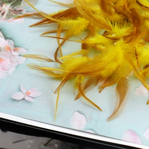 Detail of fluffy yellow feathers with natural textures for tree of life dream catcher decoration