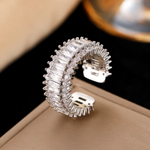 Macro shot of silver-tone open ring with baguette-cut stones and micropave zircon detail