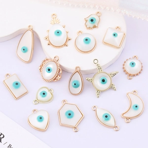 White and blue enamel evil eye charms in assorted shapes with gold-plated finish