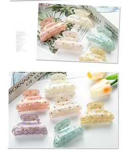 Detailed macro view of 6cm pearlescent hair claws with sparkling colorful rhinestones