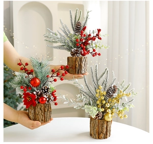 Miniature Christmas trees with berries and pinecones on a rustic wooden base