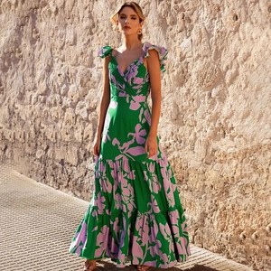 Close-up of vibrant floral green one-piece swimsuit with ruffle sleeves and V-neck detail