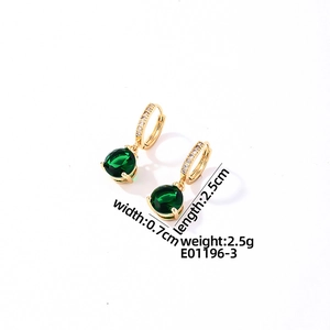 Detail view of gold earrings with green zircon pendant measuring 0.7cm wide and 2.5cm long