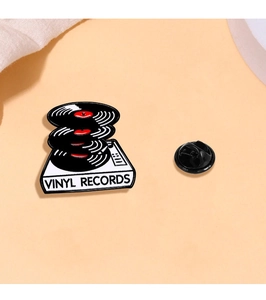 Detail of retro vinyl record player enamel pin with a durable black rubber clutch back