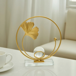 Modern gold ginkgo leaf ring ornament with crystal ball on transparent base for home decor