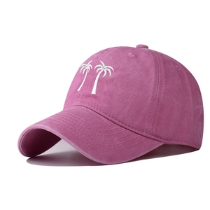Detail of rose pink washed cotton baseball cap with white coconut tree embroidery