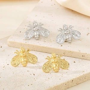 Detailed view of bee-shaped stainless steel stud earrings in gold and silver finishes