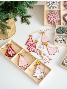 Close-up of wooden Christmas ornaments with glitter stars in a storage box