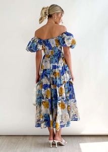 Full back view of women floral midi dress with puff sleeves and layered skirt