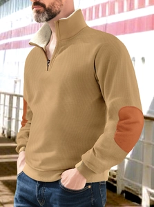 Detail of camel half-zip fleece sweatshirt featuring brown elbow patches and ribbed cuffs