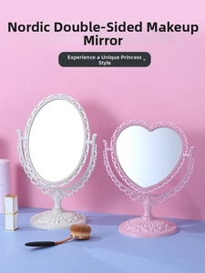 Detail of vintage heart and oval desktop vanity mirrors with embossed floral frames