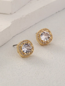Macro view of gold-plated square halo stud earrings with a clear round zircon on a stone