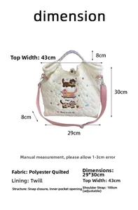 Quilted tote bag dimension guide with cat embroidery and adjustable pink shoulder strap