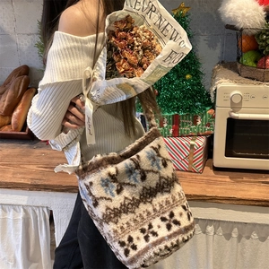 Detail of plush bucket bag featuring Nordic snowflake jacquard pattern in cozy home setting