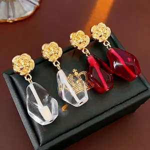 Floral geometric glass drop earrings with gold rose studs in clear and red crystal tones