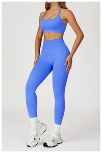 Detail view of electric blue seamless yoga bra and high-waisted leggings on a model