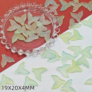 Macro view of light green iridescent fish tail glass beads for DIY jewelry making