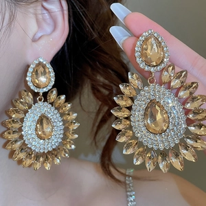 Close-up of sparkling champagne water-drop flower earrings with crystal rhinestones