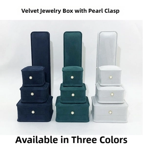 Detail of waist-shaped jewelry boxes with pearl buttons in blue, green and grey