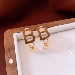 Elegant gold plated B-letter C-shape earrings with brown enamel and twist rope texture