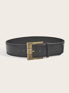Close-up of vintage black leather belt with brass buckle and decorative double stitching