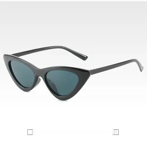 Detail view of vintage cat-eye sunglasses with black frame and dark tinted lenses