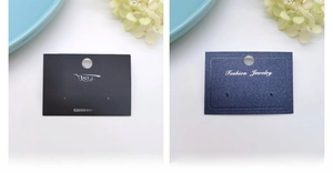 Detail of white and black paper display cards for earrings with hanging holes and jewelry slots