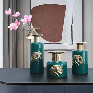 Three-piece dark green ceramic vase set with golden ginkgo leaf relief and floral accents