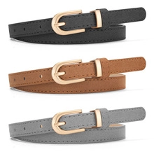 Detailed view of three faux suede belts with gold D-rings in black, brown, and grey colors