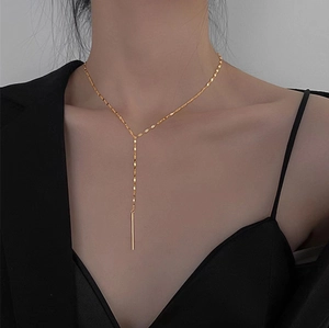 Elegant gold Y-shaped tassel necklace for women featuring minimalist bar pendant on a chain