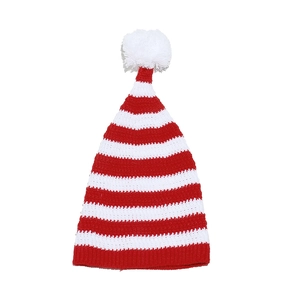 Detail of red and white striped knit Christmas hat with white pompom and ribbed cuff