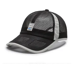 Macro view of breathable honeycomb mesh and Sport Fashion logo on black baseball cap
