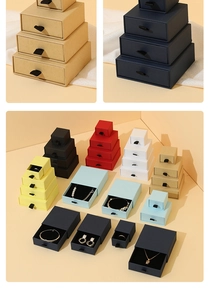 Macro shot of colorful cardboard drawer jewelry boxes with silk ribbon handles in various sizes