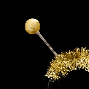Detail of gold festive headband featuring glittery balls, springs, and tinsel trim