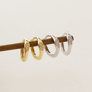 Detail view of gold and silver S925 sterling silver hoop earrings with zircon stones