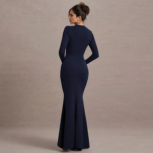 Detail view of the deep blue long-sleeve fisheye dress with a slim fit and ruffled hem