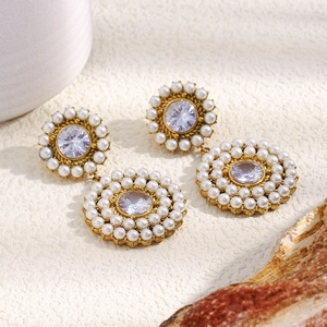 Detailed macro of 18K gold-plated earrings with pearls and round zircon stones