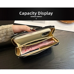 Macro view of long zipper wallet interior capacity showing card slots and phone pocket