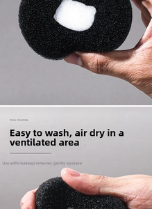 Macro detail of charcoal makeup brush sponge showing porous texture and flexibility