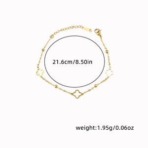 Detail view of a gold clover charm bracelet showing its 21.6cm length and 1.95g weight