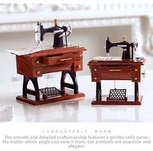 Detail of vintage sewing machine music box with wood grain texture and golden accents