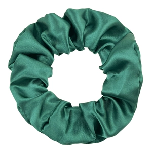 Detailed view of the dark green satin fabric texture and pleated design of the scrunchie