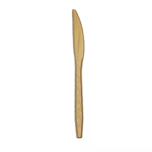 Detail of disposable golden plastic knife with decorative diamond texture on the handle