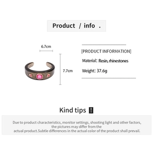 Detail view of coffee resin bangle with pink rhinestones and 6.7x7.7cm dimensions