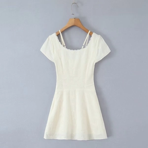 Chic white puff sleeve mini dress with lace embroidery and ruched details on a hanger
