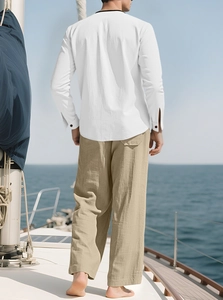 Detailed texture of white linen shirt and khaki trousers on a boat deck