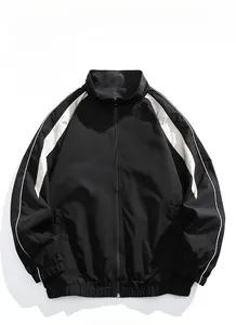 Macro detail of men's black jacket with white side stripes and ribbed elastic cuffs