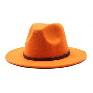 Detail of bright orange wool felt jazz hat with a dark brown slim leather decorative band