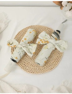 Flat lay of foldable floral umbrellas with large yellow flower patterns and elegant bow tie